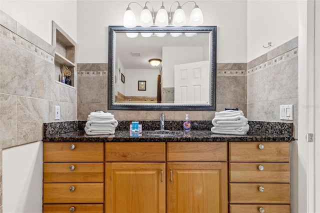 bathroom with tile walls, visible vents, and vanity