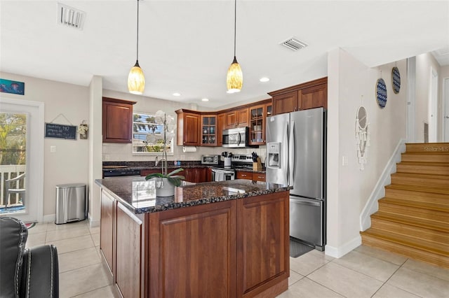 kitchen with stainless steel appliances, visible vents, light tile patterned floors, and plenty of natural light