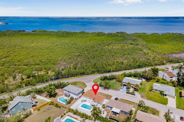 birds eye view of property featuring a wooded view and a water view