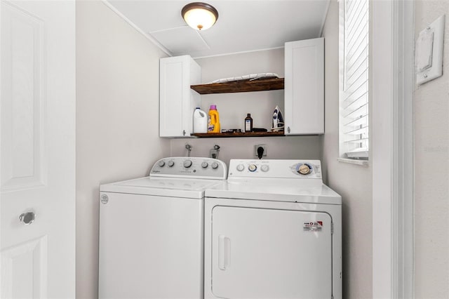 washroom with washing machine and clothes dryer and cabinet space