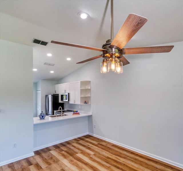 kitchen featuring visible vents, white cabinets, appliances with stainless steel finishes, light countertops, and open shelves