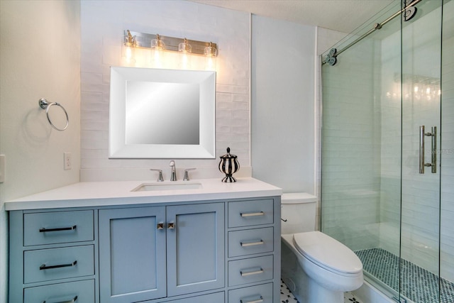 full bathroom featuring toilet, a stall shower, and vanity