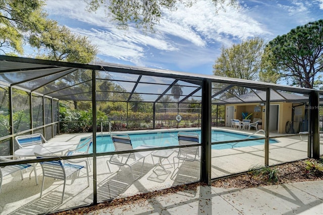 pool with a lanai and a patio area