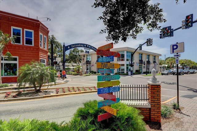 view of road featuring sidewalks, traffic lights, and curbs