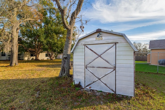 view of shed featuring fence