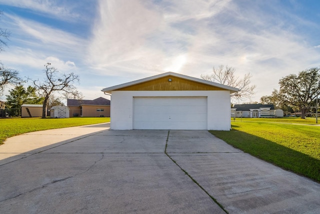 detached garage featuring a shed