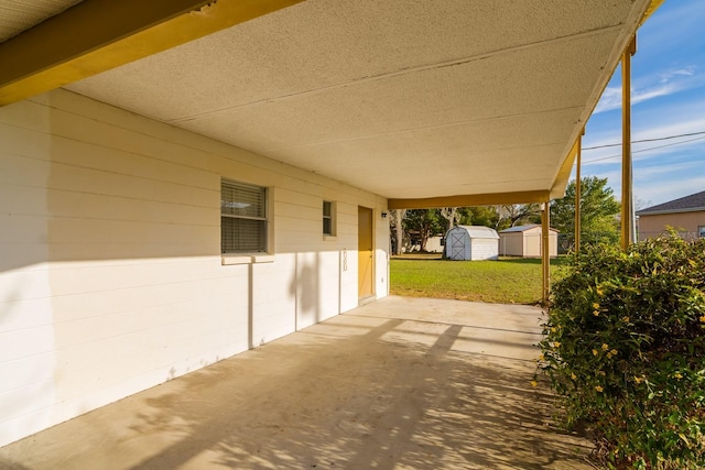 view of patio / terrace featuring a shed and an outbuilding