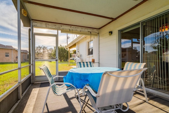 sunroom featuring beamed ceiling