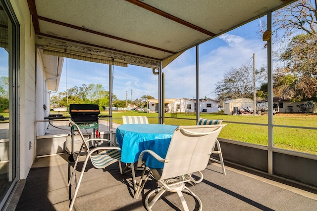 sunroom / solarium featuring a residential view