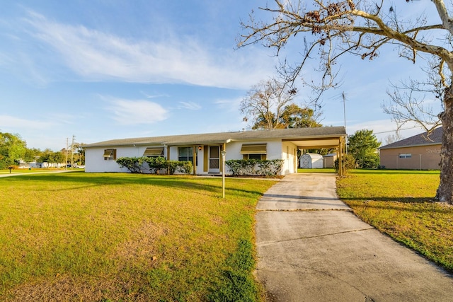 ranch-style home featuring driveway, a front lawn, a carport, and stucco siding