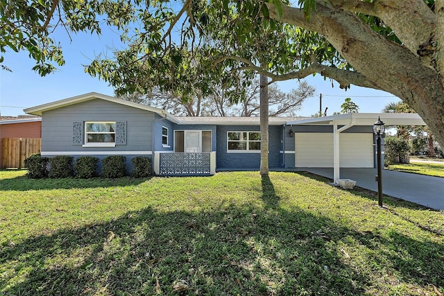 single story home with a front yard, concrete driveway, fence, and an attached carport