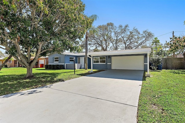 view of front of house with a garage, fence, concrete driveway, and a front yard