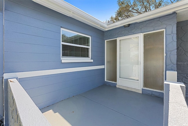 property entrance featuring a patio area