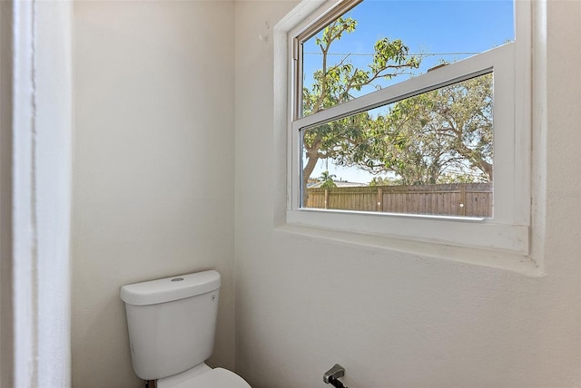 bathroom featuring plenty of natural light and toilet