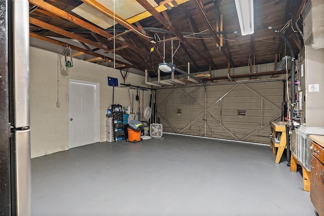 garage with freestanding refrigerator and a garage door opener