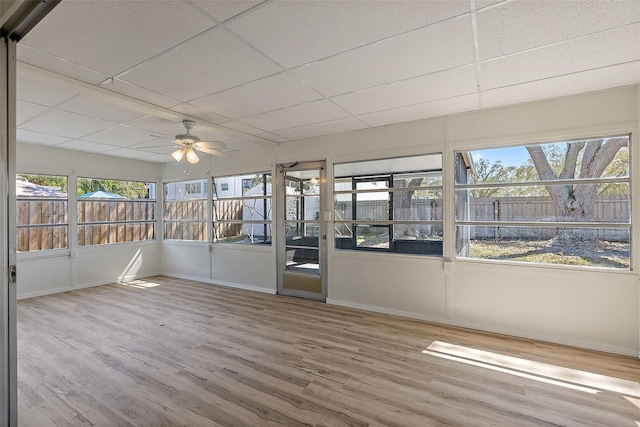 unfurnished sunroom with a paneled ceiling and ceiling fan