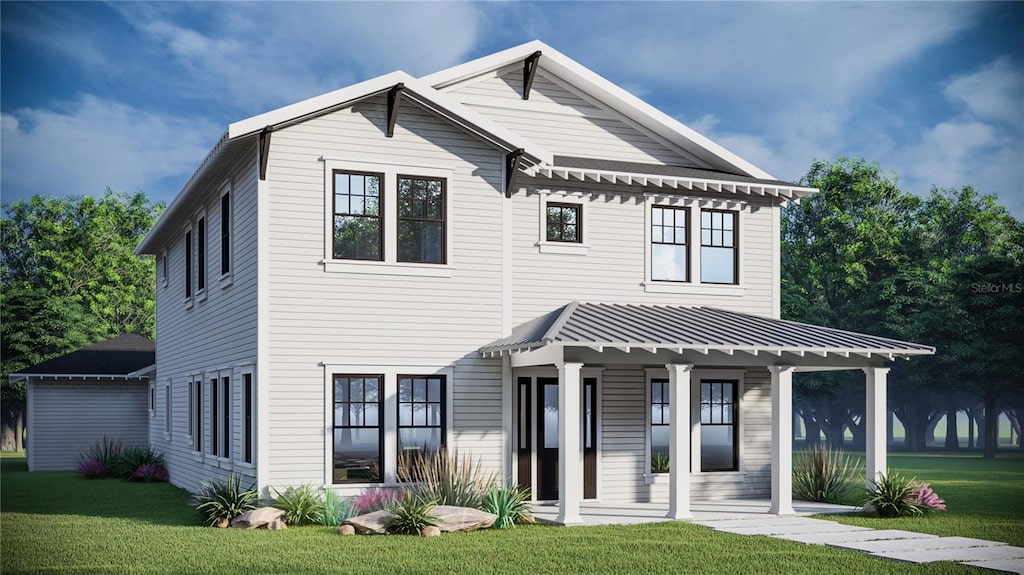 view of front facade featuring a porch, a standing seam roof, metal roof, and a front lawn