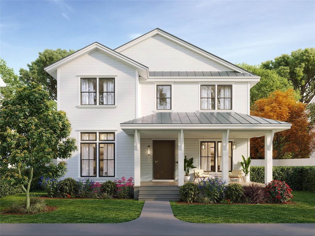 modern inspired farmhouse with a standing seam roof, metal roof, a porch, and a front yard