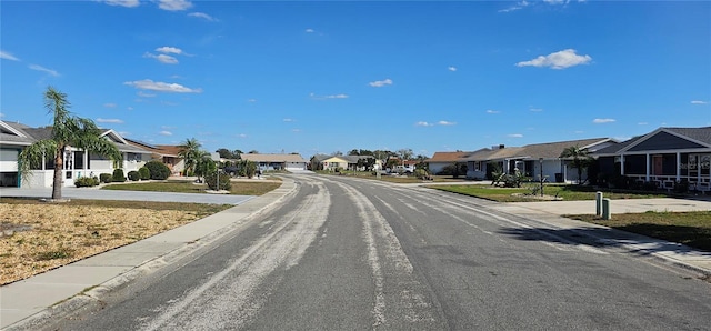 view of road featuring a residential view and curbs