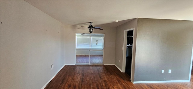 empty room with ceiling fan, baseboards, and wood finished floors