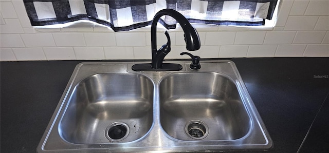 interior details featuring a sink and decorative backsplash