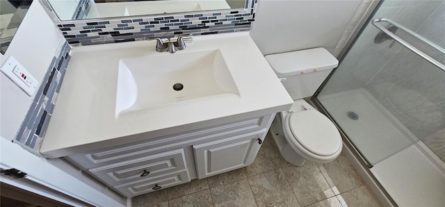 bathroom featuring a stall shower, backsplash, vanity, and toilet