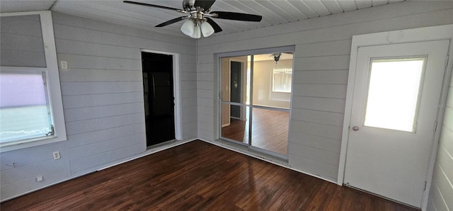 unfurnished sunroom featuring a ceiling fan