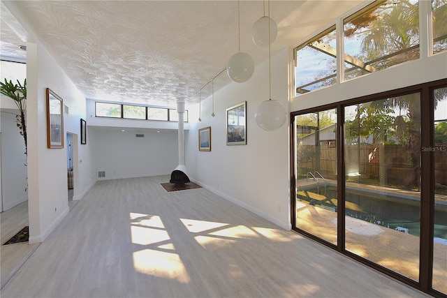 unfurnished sunroom featuring visible vents