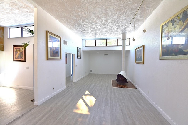 interior space featuring visible vents, baseboards, and wood finished floors