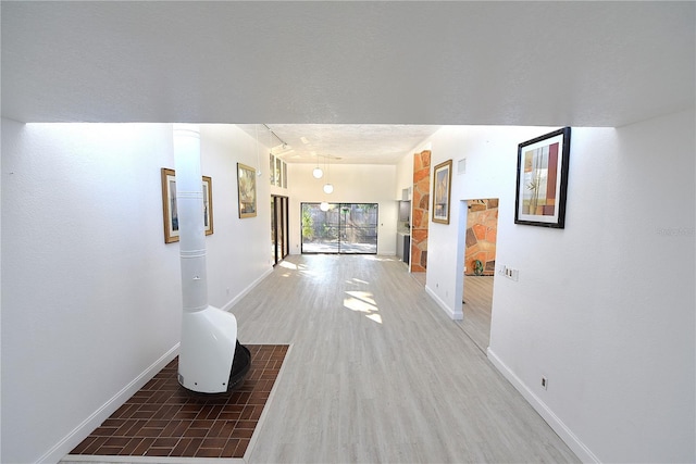 hallway with baseboards and wood finished floors