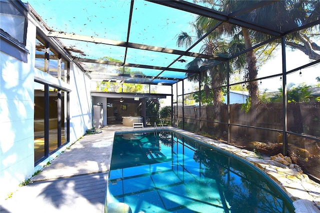 view of pool with a fenced in pool, a patio area, glass enclosure, and fence