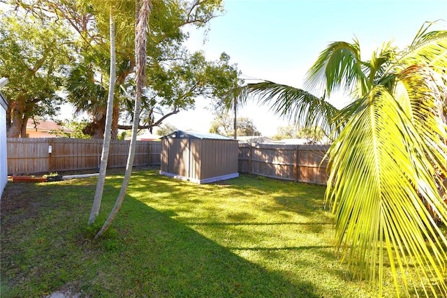 view of yard with a fenced backyard, a storage unit, and an outdoor structure