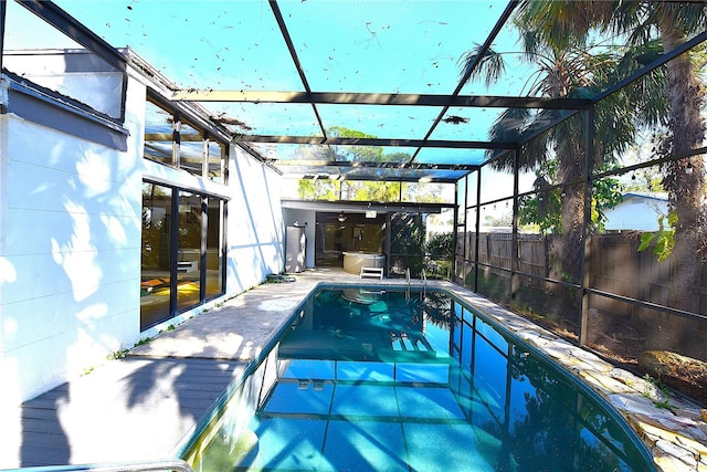 view of swimming pool featuring a patio, a lanai, a fenced in pool, and fence