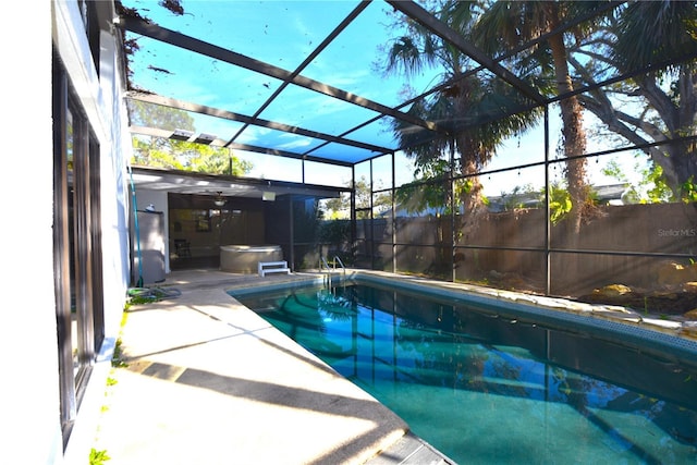 view of pool featuring a patio area, glass enclosure, and a fenced in pool