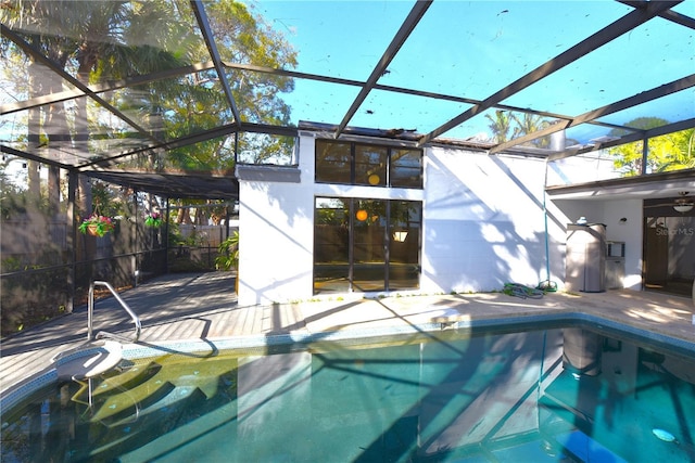 view of pool with glass enclosure, fence, a fenced in pool, and a patio