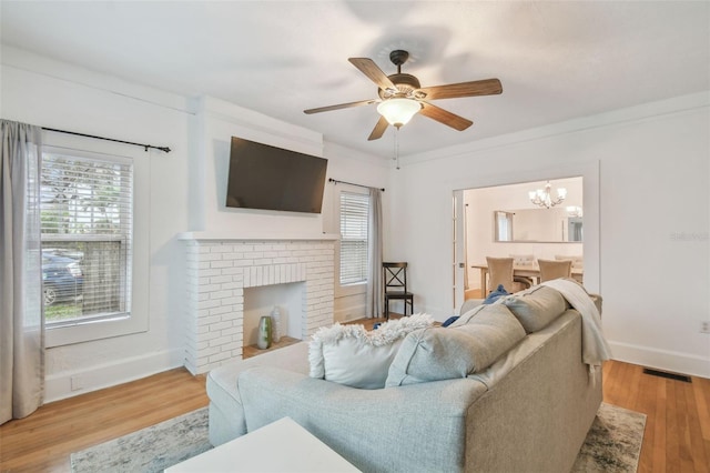 living area with plenty of natural light, light wood-style flooring, and baseboards