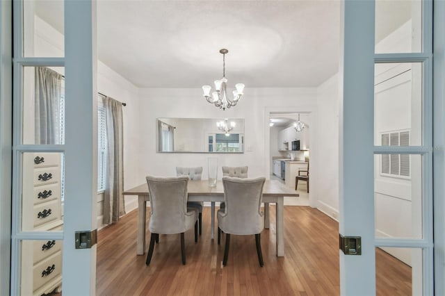 dining room with a chandelier and wood finished floors