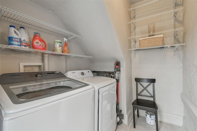 washroom with light tile patterned floors, laundry area, and independent washer and dryer