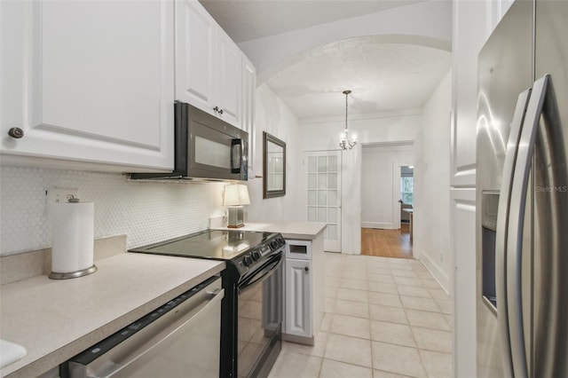 kitchen featuring pendant lighting, black appliances, light countertops, and white cabinets