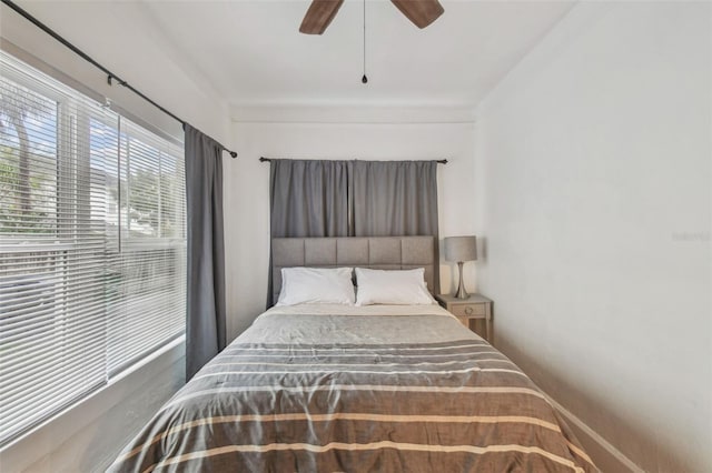 bedroom featuring a ceiling fan and baseboards