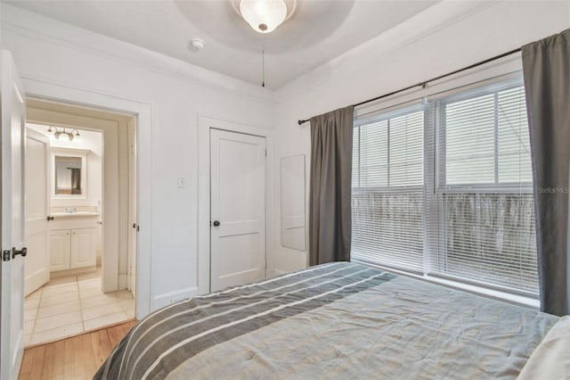 bedroom with ornamental molding, wood finished floors, and a ceiling fan