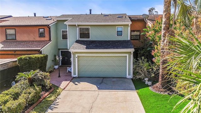 view of front of property featuring a garage, driveway, roof with shingles, and stucco siding