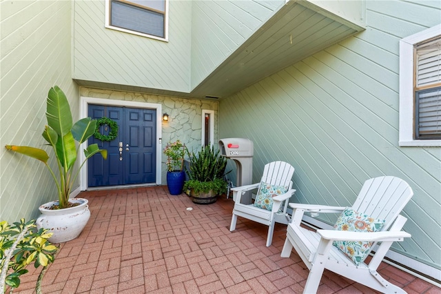 view of exterior entry featuring a patio area