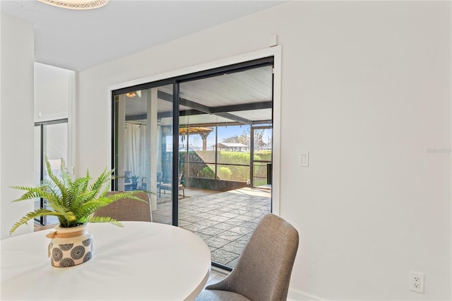 dining space featuring a sunroom