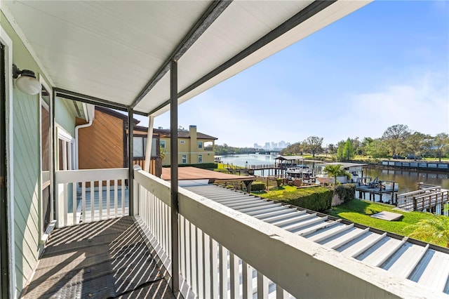 balcony with a dock and a water view