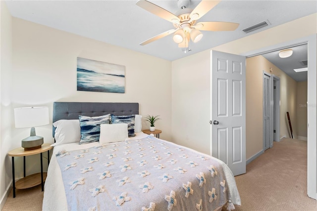 bedroom featuring light carpet, ceiling fan, and visible vents