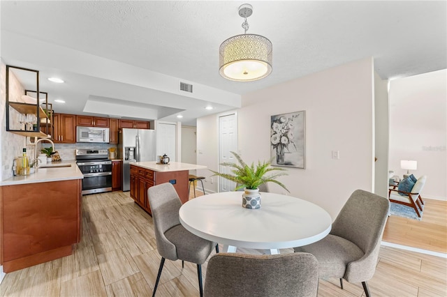 dining space featuring recessed lighting, visible vents, and light wood-style floors