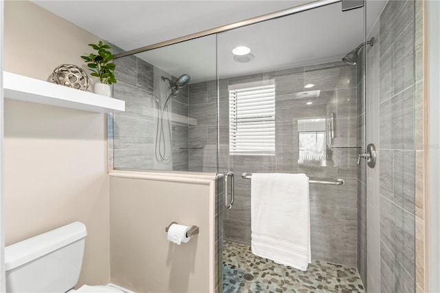 full bathroom with a stall shower and toilet