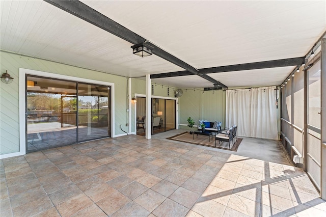 unfurnished sunroom with beamed ceiling