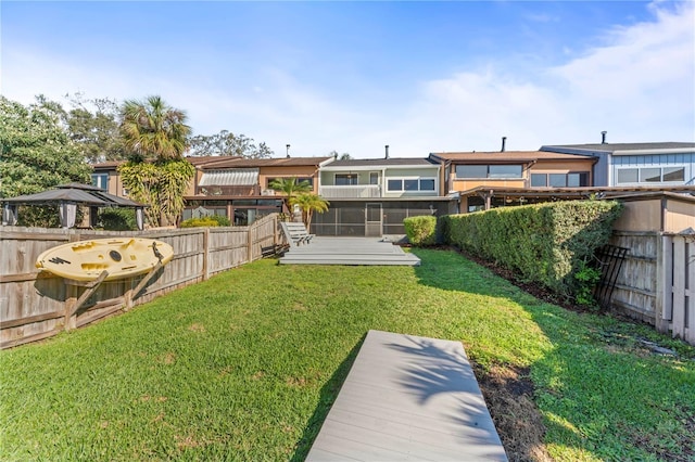 back of house featuring a yard and a fenced backyard